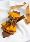 High-quality mustard yellow and gold fabric of the handmade women's bow tie