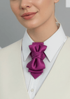 Woman wearing a cream vest over a white shirt with a purple bow tie against a geometric patterned  fashionable, elegant, sophisticated, chic, modern, unique, exclusive, luxurious, high-end, premium, quality, handmade, artisan, bespoke, tailored, custom, designer, trendy, vogue, modish, smart, classy, stylish, fashion-forward, contemporary, women's fashion, ladies' wear, apparel, clothing, attire, garment, outfit, ensemble, get-up, dress, gown, frock, top, blouse, shirt, sweater, jacket, coat, blazbackground