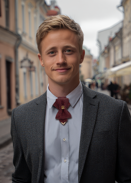 Man in a suit and tie standing on a street with buildings in the background red black striped jabot tie, gold Gedimino stulpai emblem, handmade heritage necktie, Lithuanian cultural fashion, artisan jabot-style tie, elegant striped tie gold badge, luxury heritage necktie, cultural fashion accessory, Lithuanian identity tie, formal jabot tie, handcrafted Lithuanian motif tie