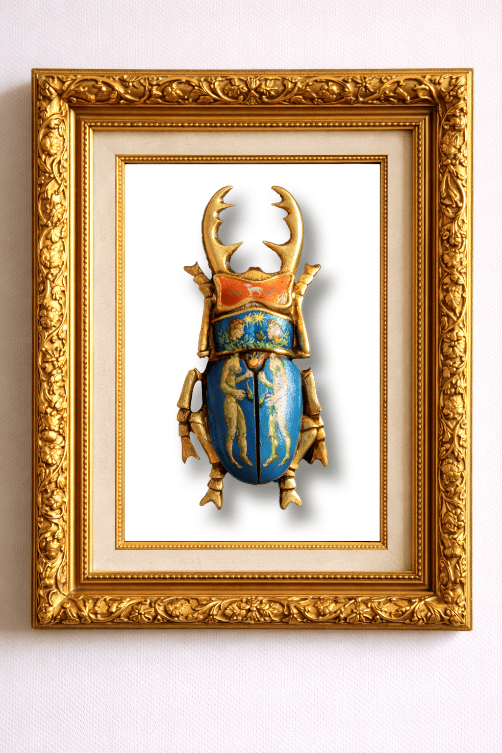 Decorative beetle sculpture with gold and blue details in a gold frame on a white background
