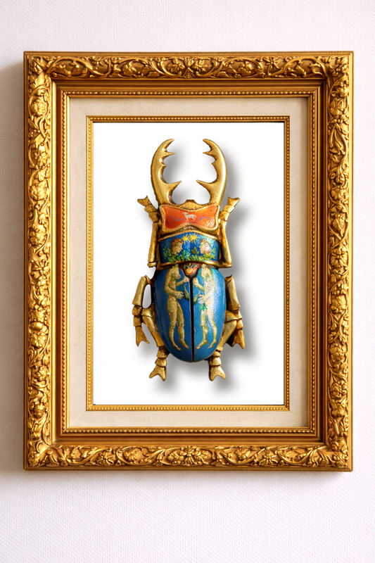 Decorative beetle sculpture with gold and blue details in a gold frame on a white background