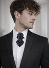 black statement tie for men, luxury handmade necktie, artistic groom tie, modern wedding tie, unique formal neckwear, sculptural bow tie alternative, elegant men accessory, minimalist black tie, stylish groom outfit detail, contemporary cravat style tie, designer neckwear piece, formal event accessory, premium fabric tie, sophisticated men fashion, standout wedding look, avant garde tie, tailored suit accessory, refined black necktie