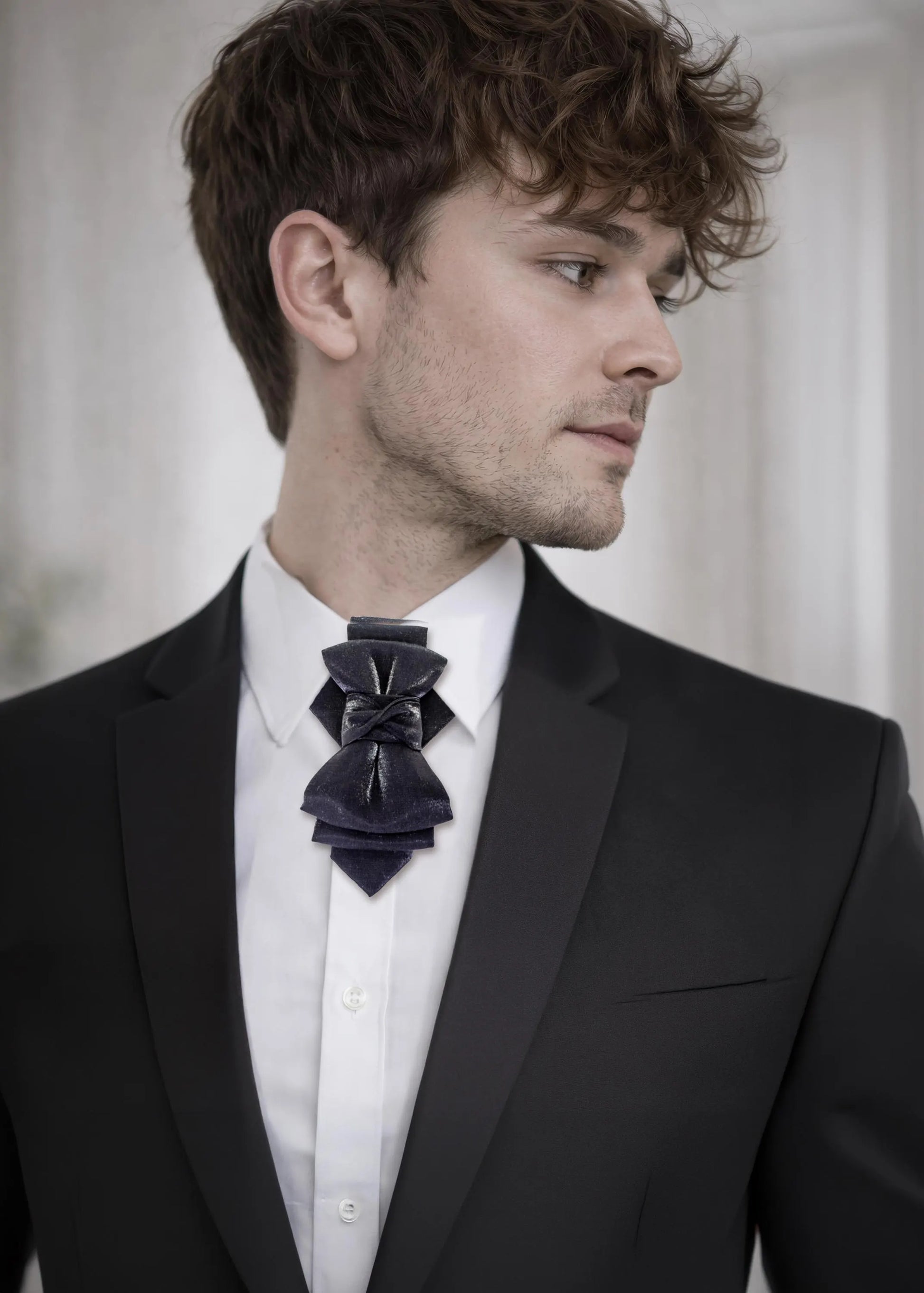 black statement tie for men, luxury handmade necktie, artistic groom tie, modern wedding tie, unique formal neckwear, sculptural bow tie alternative, elegant men accessory, minimalist black tie, stylish groom outfit detail, contemporary cravat style tie, designer neckwear piece, formal event accessory, premium fabric tie, sophisticated men fashion, standout wedding look, avant garde tie, tailored suit accessory, refined black necktie