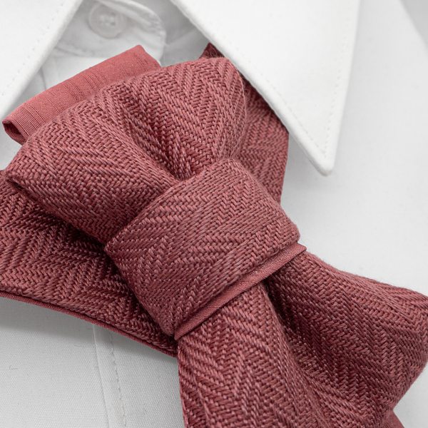 Close-up of a knitted pink tie on a white shirt