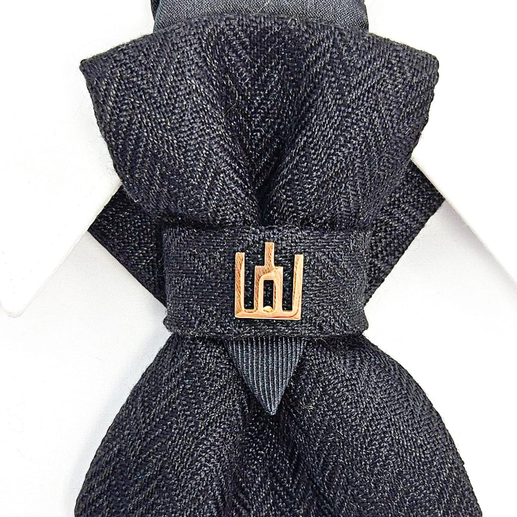 Dark gray textured bow tie with a gold clasp on a white background Handmade luxury dark navy blue wool bow tie with leather neck strap and unique gold-tone monogrammed clip. Pre-tied cravat for groom, weddings, formal events, and special occasions. Perfect sophisticated men's accessory.