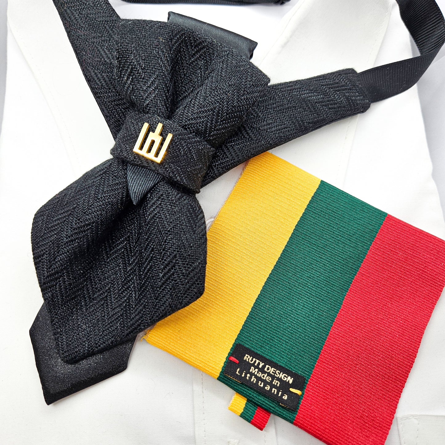 Black textured bow tie and colorful striped tie on a white background Handmade luxury dark navy blue wool bow tie with leather neck strap and unique gold-tone monogrammed clip. Pre-tied cravat for groom, weddings, formal events, and special occasions. Perfect sophisticated men's accessory.