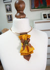 Elegant gold bow tie for women styled as a formal neck accessory