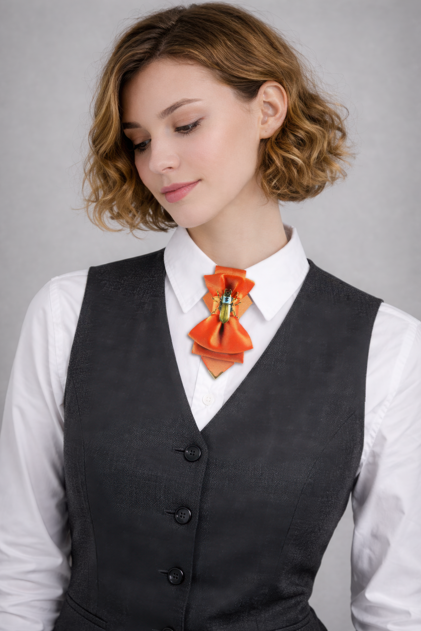 Woman wearing a black vest over a white shirt with an orange bow tie against a gray background Hopper tie, Orange bow tie, Yellow bow tie, Summer neck accessory, Unique bow tie, Designer neckwear, Artistic bow tie, Unisex necktie, Statement tie, Gold insect bow tie, Pendant bow tie, Versatile bow tie, Fashion bow tie, RutyDesign tie, Orange dream tie, Lithuanian design tie, One of a kind tie, Handmade bow tie, Modern bow tie, Bold color tie, Elegant unisex accessory, Adjustable hoop tie, Orange fashion acce