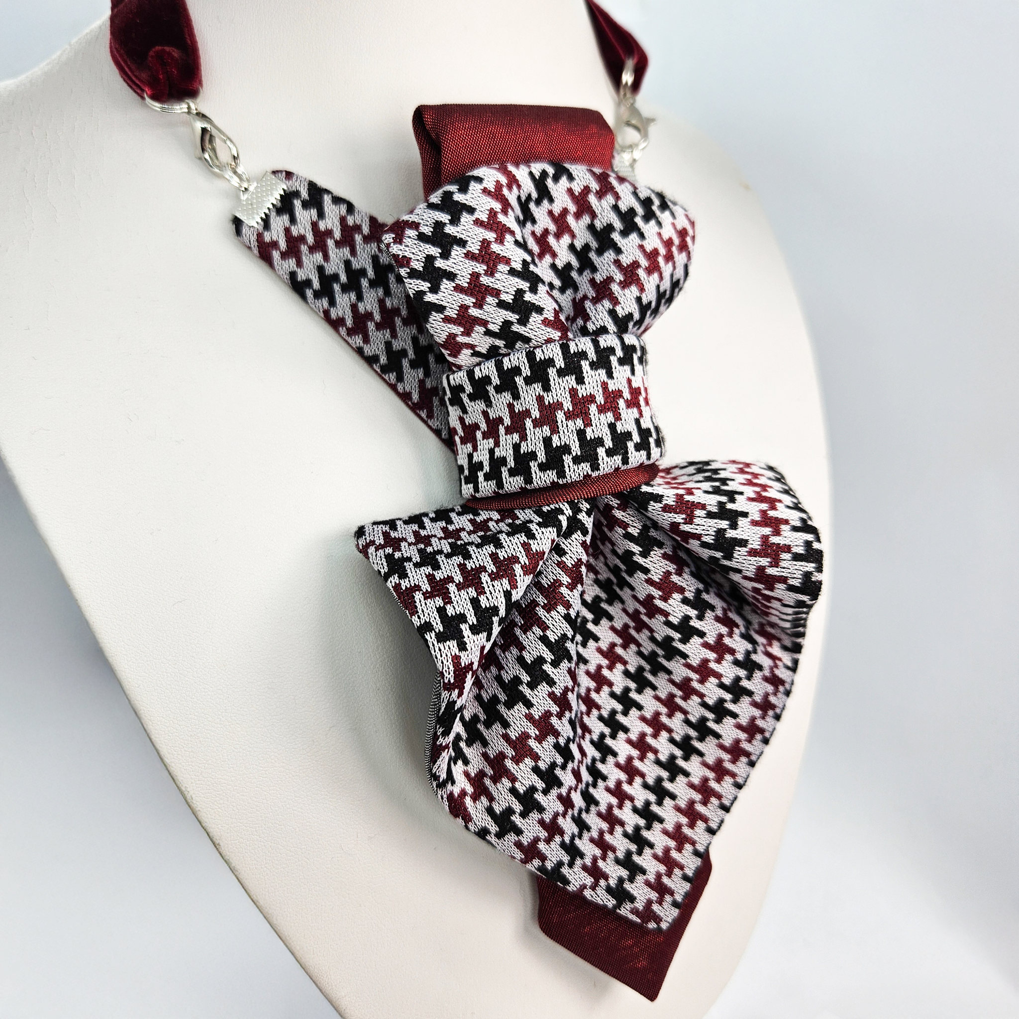Pair of houndstooth patterned socks on a white background premium handmade knitted houndstooth tie in burgundy, luxury italian silk wool blend necktie with red pied-de-poule pattern, unique red and black patterned tie for wedding or business attire, close-up of high-quality wool knit scarf style tie with abstract design, elegant burgundy and black dogtooth patt