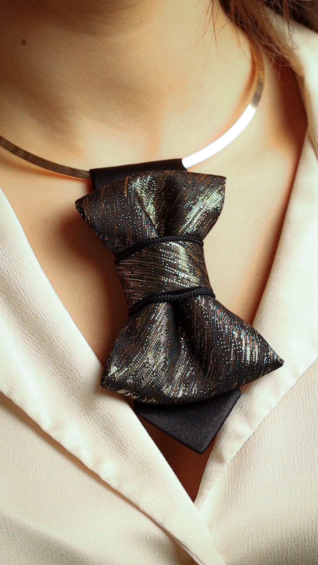 black gold womens necktie, luxury necktie for women, handmade necktie, statement accessory, elegant womens tie, unique gift for her, versatile neckwear, brooch pendant tie, modern necktie, Rūta Piekurienė design, Lithuanian handmade tie, formal accessory women, artistic necktie, special occasion tie, fashion tie for women, pre tied womens necktie, designer neckwear, black and gold tie, edgy womens fashion, dressy necktie