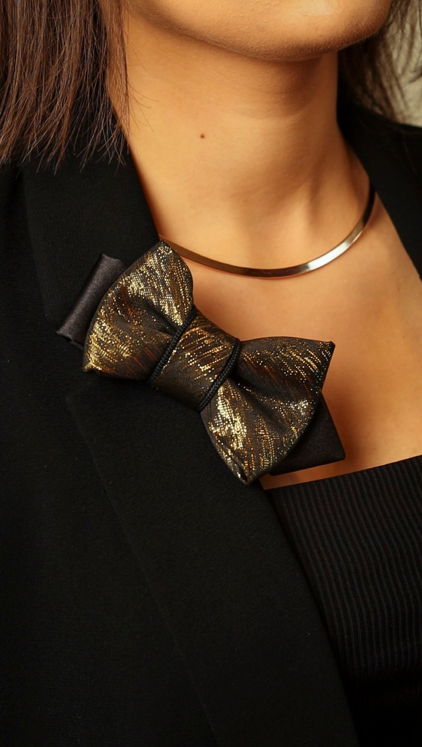 black gold womens necktie, luxury necktie for women, handmade necktie, statement accessory, elegant womens tie, unique gift for her, versatile neckwear, brooch pendant tie, modern necktie, Rūta Piekurienė design, Lithuanian handmade tie, formal accessory women, artistic necktie, special occasion tie, fashion tie for women, pre tied womens necktie, designer neckwear, black and gold tie, edgy womens fashion, dressy necktie
