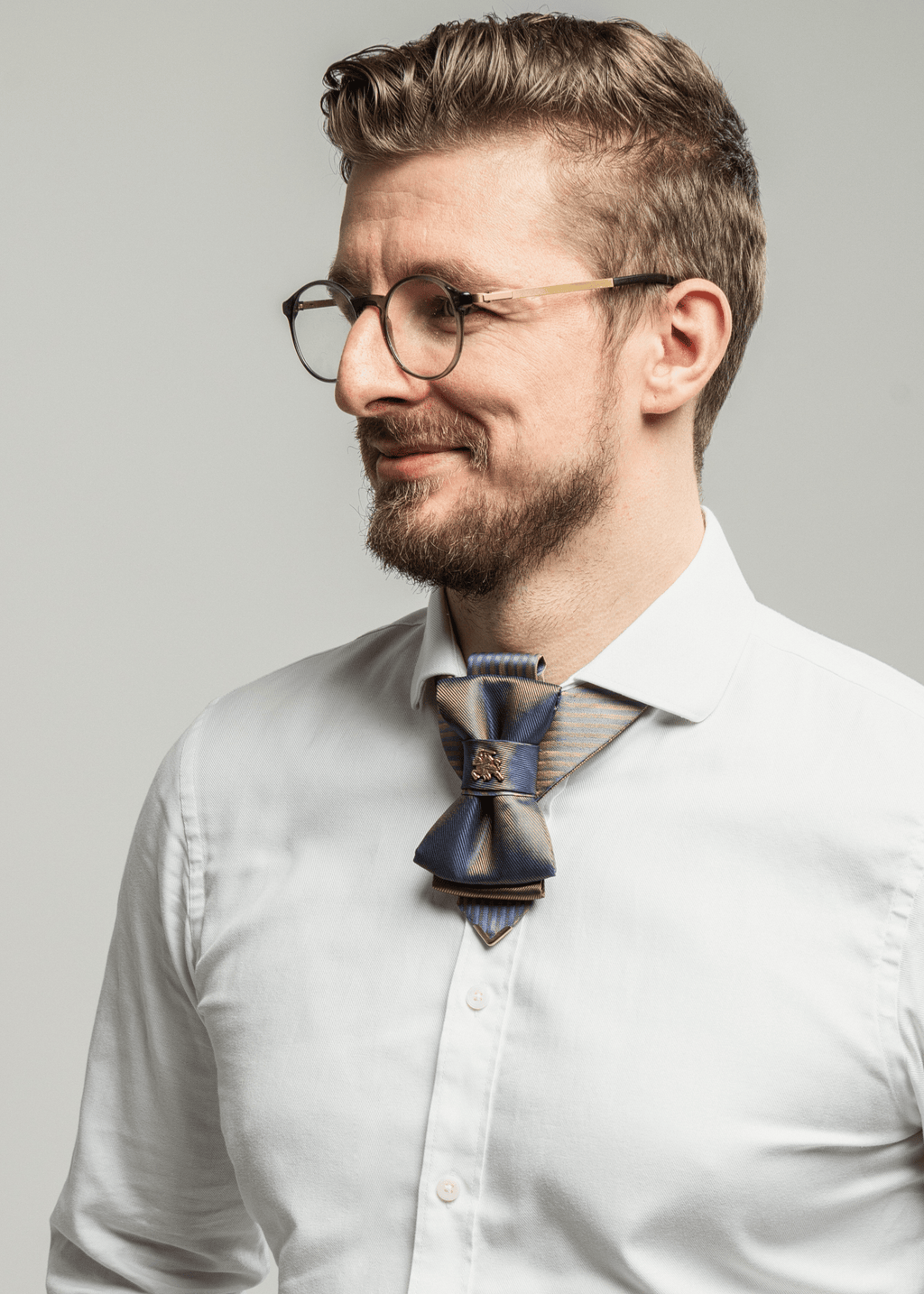Multichrome  blue khaki bow tie, Bow tie "Vilnius 700",Bow tie "Vilnius 700" is a work, dedicated to the birthday of Vilnius, the capital of Lithuania.  Brass Vytis adorns the original knot of three fabrics.