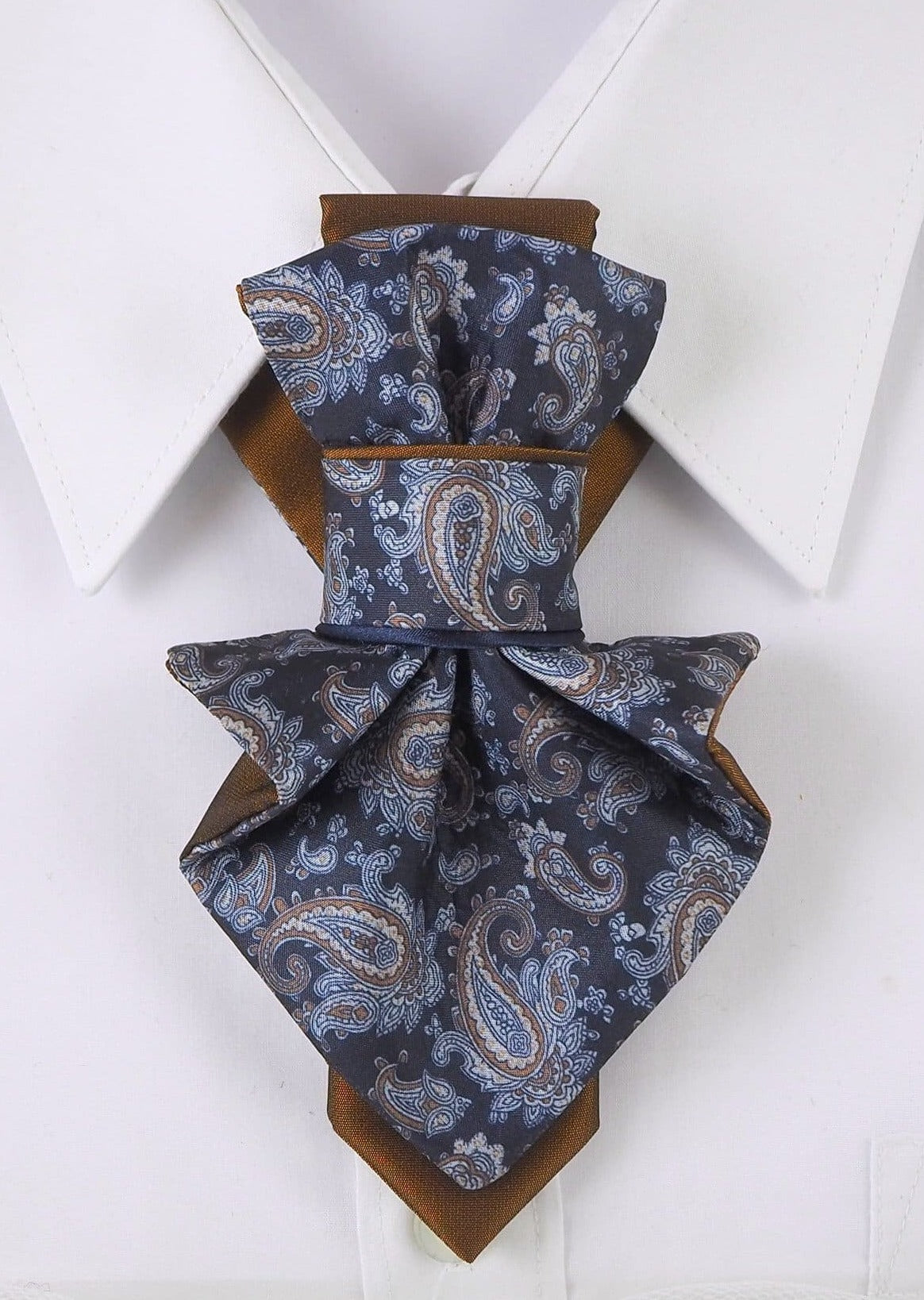 paisley women necktie close up, handmade paisley neck accessory for women, luxury women jabot tie paisley pattern, artistic fabric necktie worn on white shirt, elegant women neckwear with paisley design, statement neck accessory for women, brown blue paisley necktie detail, vertical women necktie fashion photo, handmade textile neck ornament, sophisticated women neck tie close up
