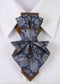 paisley women necktie close up, handmade paisley neck accessory for women, luxury women jabot tie paisley pattern, artistic fabric necktie worn on white shirt, elegant women neckwear with paisley design, statement neck accessory for women, brown blue paisley necktie detail, vertical women necktie fashion photo, handmade textile neck ornament, sophisticated women neck tie close up
