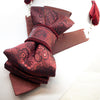 red bow tie, vertical bow tie, luxury womens tie, handmade tie, statement neckwear, unique bow tie, elegant tie for women, double-sided tie, brooch tie, pendant tie, rose wine tie, wedding accessory, business fashion, fashion necktie, Rūta Piekurienė design, artistic tie, unisex tie, special occasion tie, decorative tie, floral pattern tie, modern bow tie, Lithuanian handmade, pre-tied bow tie, gift for her
