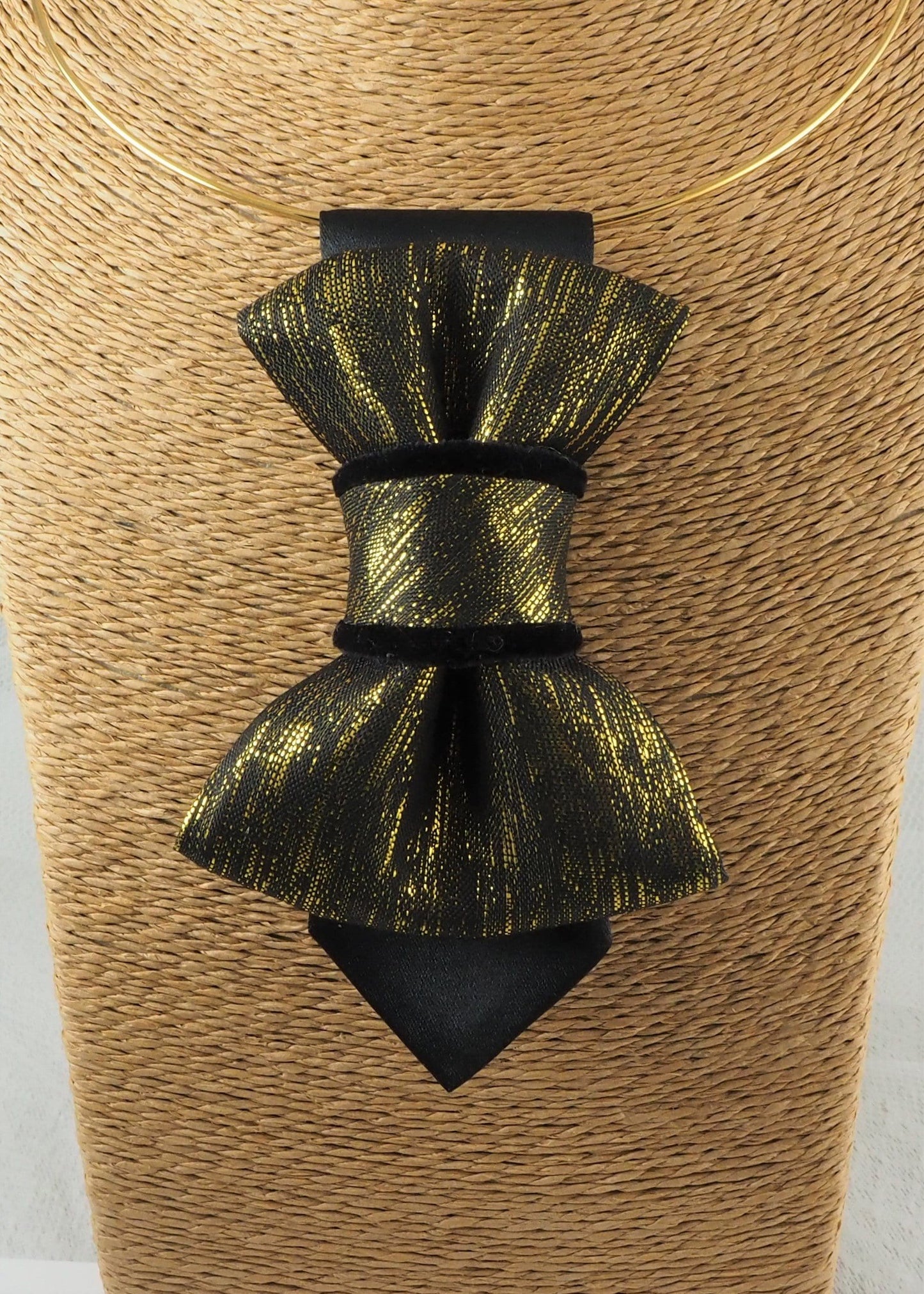 black gold womens necktie, luxury necktie for women, handmade necktie, statement accessory, elegant womens tie, unique gift for her, versatile neckwear, brooch pendant tie, modern necktie, Rūta Piekurienė design, Lithuanian handmade tie, formal accessory women, artistic necktie, special occasion tie, fashion tie for women, pre tied womens necktie, designer neckwear, black and gold tie, edgy womens fashion, dressy necktie HOPPER TIE THE GOLDEN FOR LADY.