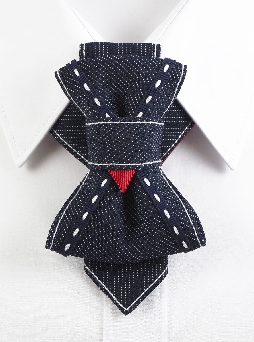 Bow Tie, Tie for wedding suite WINSTON hopper tie Bow tie, Handmade luxury tie "Wilson" with layered navy design and red accent

Unique wedding tie for men with white stitching and folded structure

Artistic necktie for groom – navy with fine pinstripes and red detail

"Wilson" designer necktie with geometric knot and bold statement look

Formal men’s accessory – navy handmade tie with contrast thread

Unisex sculptural tie with modern twist for weddings and performances

Luxury groom tie by Rūta Piekurienė