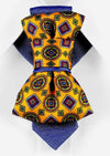 HOPPER TIE THE SUNNY ARABESCO Yellow patterned necktie, blue shirt, geometric design, men's fashion, stylish accessory, unique tie, artistic, colorful, handcrafted, elegant, Finnish design inspiration.
